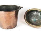 a small copper pot next to a larger copper pot
