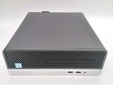 the back of a small computer with a keyboard on top of it