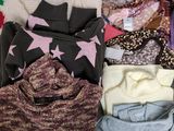 a pile of sweaters and sweaters sitting on a table