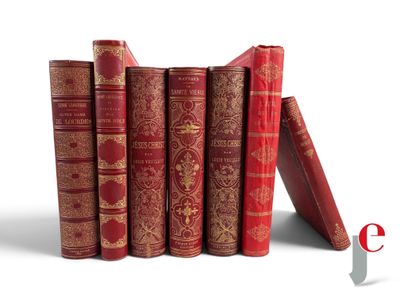 several red books are stacked on top of each other on a white surface