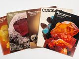 three books on a table with a white background and a white background
