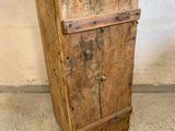 a wooden cabinet with a metal top on a concrete floor