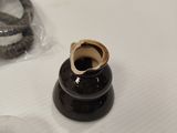 a black vase with a gold ring on top of it
