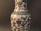 a vase with a lamp on top of it on a table