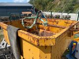 a yellow dump truck with a blue handle on the back of it