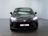 the front view of a black sports car in a showroom
