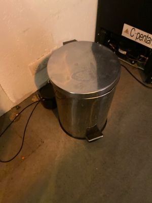 an image of a trash can next to a tv