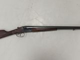a rifle that is laying on top of a white wall