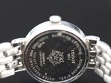 a close up of a watch on a black surface