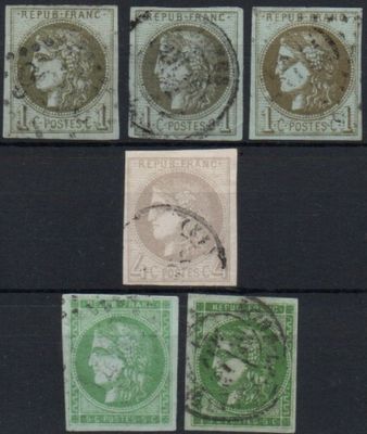 a close up of a group of stamps on a black surface