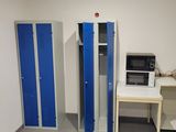a microwave and a microwave oven in the corner of a room