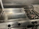 a stove top with a frying pan on it in a kitchen