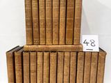 several old books stacked on top of each other with a price tag