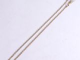 an image of a gold chain that has been placed on a white surface