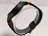 a close up of a watch on a clear stand