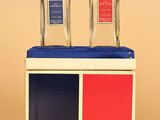 two bottles of cologne sitting on top of a box on a table