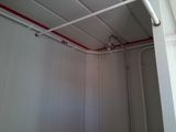 a room with a white wall and a red line on the ceiling