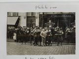 photograph of a group of people standing in front of a building