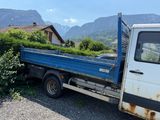 a blue truck that is parked in the dirt