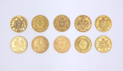 several gold coins are arranged in a row on a white surface