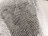 a mesh bag on top of a white counter