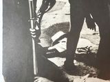 a black and white photo of a man holding a baseball bat