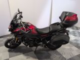 a red and black motorcycle parked on a checkered floor