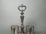an antique silver plated tea set with cups and saucers