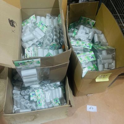 two boxes of toilet paper on the floor next to each other