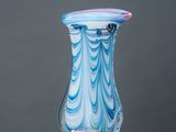 a glass vase sitting on top of a white pedestal