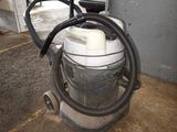 a vacuum that is sitting on the floor in the garage