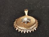 a close up of a gold locke with a pearl in the center