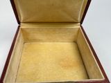 a small wooden box that is open on a white surface