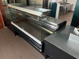 a glass display case in the middle of a kitchen