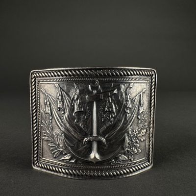 a close up of a silver belt buckle on a black background