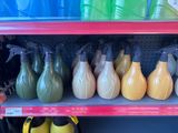 many different colored spray bottles on a shelf