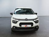 the front of a white citrole parked in a room