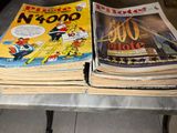 a lot of comics sitting on a table together