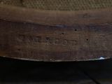 a close up view of a brown shoe on a wooden floor