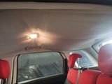 an image of a car with red seats and a ceiling