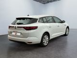the rear end of a white car in a white room