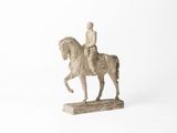 figurine of a man riding a horse on a white background