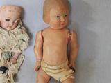two dolls that are next to each other on a table