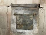 a metal box with a sign on it on a pedestal