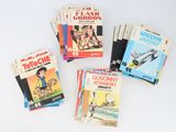 several children ' s books sitting on top of each other on a table