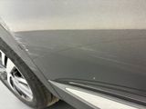a close up view of a car ' s front bumper with scratches on it