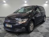 the volkswagen touran is parked in a large room with a checkered floor