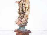 an image of a statue of the virgin of guadalupe on a wooden base