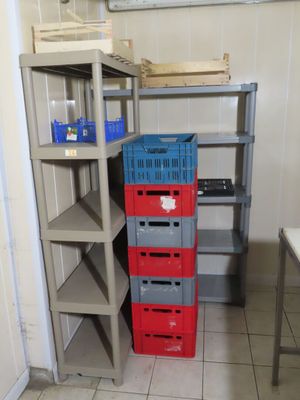 a stack of crates sitting on a shelf in a room