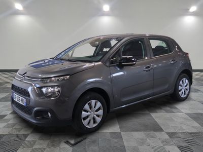 the grey citrole is parked on a checkered tile floor